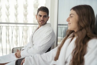 Genç mutlu çift otel odasında kahvaltı yapıyor.