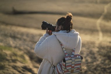 Dağlardaki tarlada kameralı bir kız.
