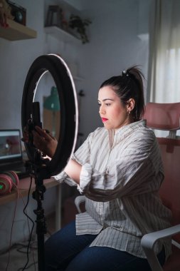 Genç bayan blogcu bir video üzerinde kayıt stüdyosu yapıyor.