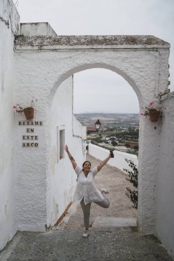 Öndeki beyaz elbiseli kadın.