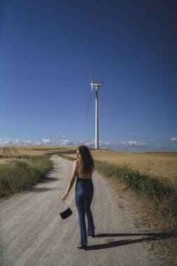 Rüzgâr değirmeninin önünde genç bir kadın