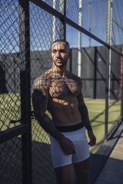 Dövmeli kaslı bir adam.