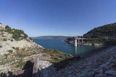 Mavi bulutlu gökyüzünün altındaki bir dağın güzel bir görüntüsü.