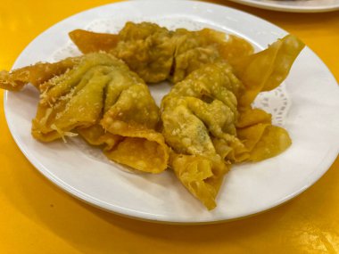 Deep fried gyoza crispy and golden colour set on white plate