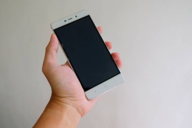 Akıllı telefon beyaz arkaplan tutan adam