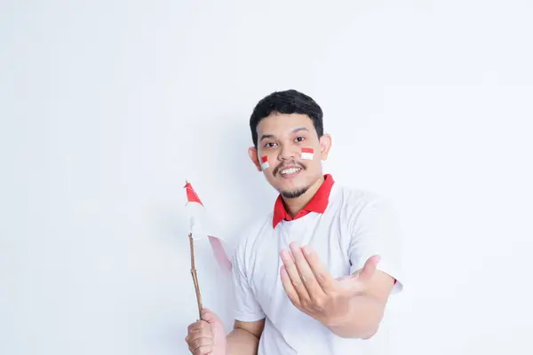 stock image Adult Asian man showing excited expression while asking someone to follow him gesture, celebrating indonesia independence day