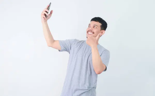 stock image Adult Asian man taking a selfie photo with happy expression