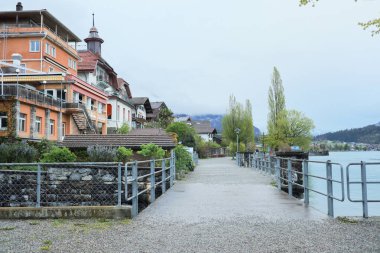 Kış kıyafetleri giyen Asyalı bir kadın, Brienz İsviçre 'nin manzarasının tadını çıkarıyor.
