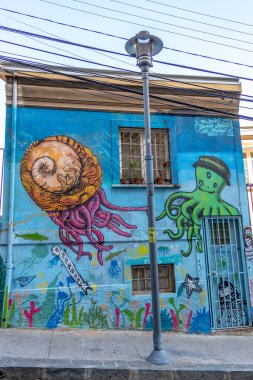 Valparaiso, Chile - Dec 5, 2022: Colorful houses full of graffiti on a steep street of Valparaiso, which has been declared as a World Heritage Site by UNESCO