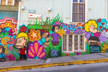 Valparaiso, Chile - Dec 5, 2022: Colorful houses full of graffiti on a steep street of Valparaiso, which has been declared as a World Heritage Site by UNESCO