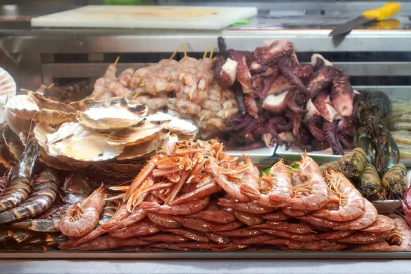 Prawns, oysters and octopus on a market display to prepare a meal for sale