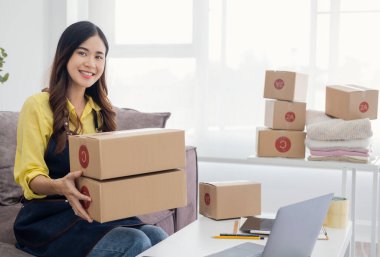 Small Entrepreneurs Start A Home Business By Arranging Goods With Brown Parcel Boxes, Small Home Business Startup Ideas.