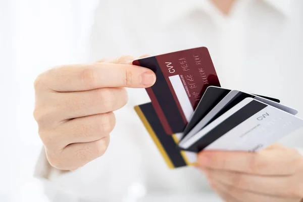 stock image woman choose one credit card from many, concept of credit card debt,