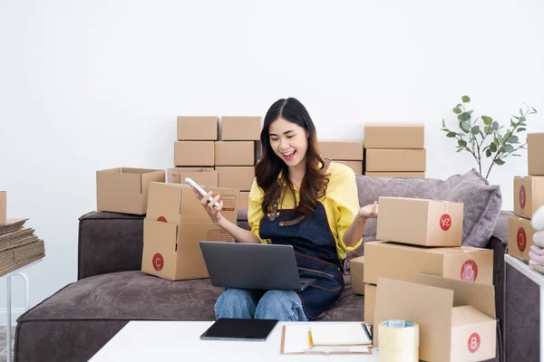 Young asian women happy after new order from customer. Surprise and shock face of asian woman success on making big sale of her online store. Online Selling. Online Shopping