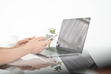 Çevrimiçi alışveriş kavramı, kadın eli cep telefonu ve kredi kartı. Evde dinlenirken akıllı telefon ve dizüstü bilgisayar kullanan kadın elleri.