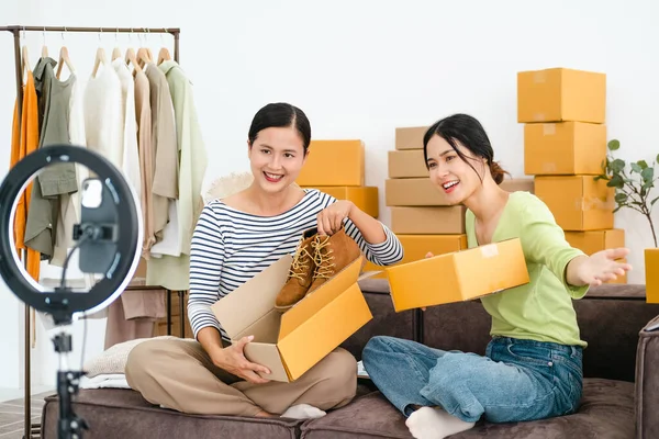 Young woman Online seller owner working for e-business commerce. Business owner checking and packing online order to delivery during sale seasonal.Online Shopping and e-Commerce concept.