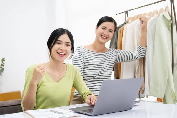 Young asian women happy after new order from customer. Surprise and shock face of asian couple success on making big sale of her online store. Online Selling. Online Shopping