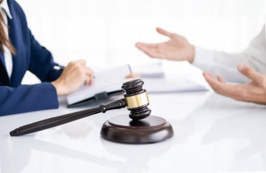 Professional female lawyer or counselor discussing negotiation legal case with client meeting with document contract in office, law and justice, attorney, lawsuit concept.