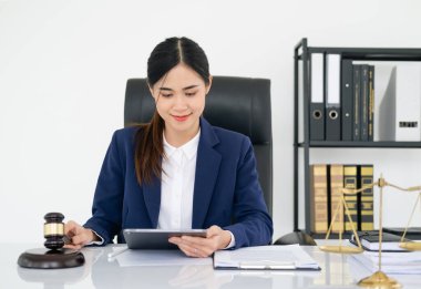 Business Asian woman in suit and Lawyer working on a documents at workplace office. Judge gavel with Justice lawyers, Legal law, advice and justice concept