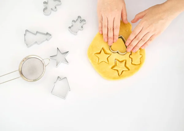 Making for homemade biscuits. On the table is dough and a set of cookie molds with other kitchen equipment. Cute baby cookies in the shape of  a heart and a tree. Cooking with baking tools.Top view. Copy Space