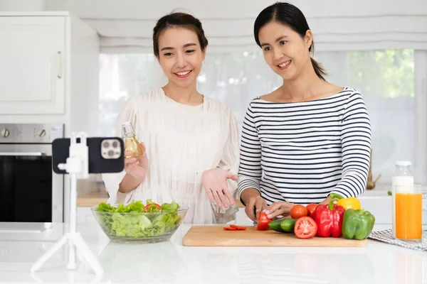 Asia girlfriends vlogger look camera filming shoot live share vlog. Gen Z youth people enjoy cooking  healthy food breakfast dinner lunch with fun joy party laugh relax smile.