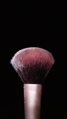 Vertical Screen: Makeup Brushes Touch Each Other on Dark Background and Small Particles of Cosmetics, Beauty Concept Super Slow Motion Content Shot for Social Media. High quality footage