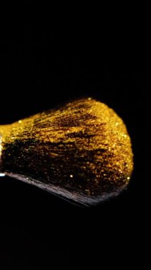 Vertical Screen: Makeup Brushes Touch Each Other on Dark Background and Small Particles of Cosmetics, Beauty Concept Super Slow Motion Content Shot for Social Media. High quality footage