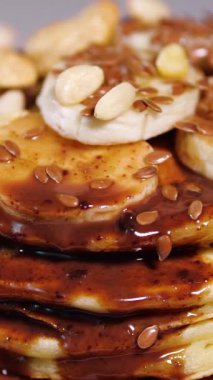 Vertical Screen: Sweet pancakes with chocolate syrup. Healthy grilled food cooked at home. Delicious Breakfast Food with Bananas and Chocolate. Shot for Social Media. High quality footage
