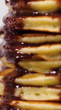 Vertical Screen: Sweet pancakes with chocolate syrup. Healthy grilled food cooked at home. Delicious Breakfast Food with Bananas and Chocolate. Shot for Social Media. High quality footage