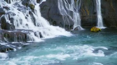 Autumn Waterfall in Iceland. Pure Turquoise Water in Mountain River. Popular Tourist Spot. Famous Travel Destination. Beautiful Nature, Unusual Landscape. Footage Shot in 8K Resolution 4320p.