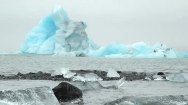 Iceberg in Foggy Glacier Lagoon, Nature in Iceland. Beautiful Natural Miracle in North Country. Pure Blue Ice at Winter Season. Blocks of Ice Wash Up on the Shore Shot in 8k Resolution.