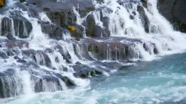Autumn Waterfall in Iceland. Pure Turquoise Water in Mountain River. Popular Tourist Spot. Famous Travel Destination. Beautiful Nature, Unusual Landscape. Footage Shot in 8K Resolution 4320p.