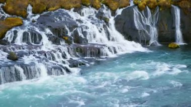 Autumn Waterfall in Iceland. Pure Turquoise Water in Mountain River. Popular Tourist Spot. Famous Travel Destination. Beautiful Nature, Unusual Landscape. Footage Shot in 8K Resolution 4320p.