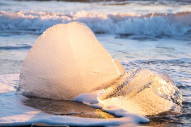 Diamond Beach in Iceland. Icebergs Shining on Black Volcanic Sand at Sunset. Clear Ice Crashed by Ocean Waves. Famous Tourist Location in North Europe Country. Travel Destination. High Resolution.