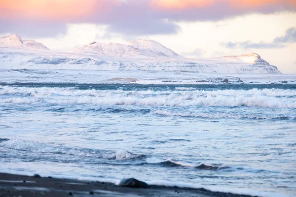 Icelandic Fjords During Sunset. Ocean Coast With Snow Covered Mountains. Winter Landscape in the North Europe Country. Landscape in Iceland.