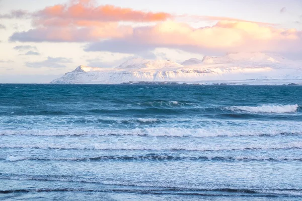 Icelandic Fjords During Sunset. Ocean Coast With Snow Covered Mountains. Winter Landscape in the North Europe Country. Landscape in Iceland.