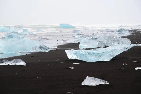 Diamond Beach in Iceland. Incredible Landscape with Pure Blue Icebergs on Black Sand. Shore Near Jokulsarlon glacier lagoon. Global Warming Concept. Vatnajokull National Park, southeast Iceland.