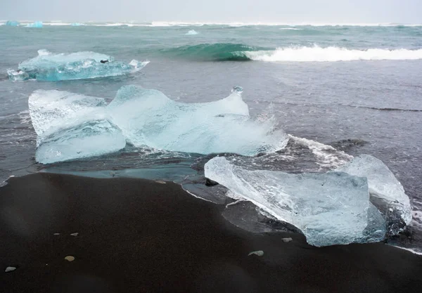 Diamond Beach in Iceland. Incredible Landscape with Pure Blue Icebergs on Black Sand. Shore Near Jokulsarlon glacier lagoon. Global Warming Concept. Vatnajokull National Park, southeast Iceland.