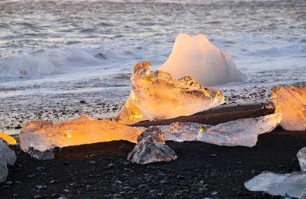 Diamond Beach in Iceland. Icebergs Shining on Black Volcanic Sand at Sunset. Clear Ice Crashed by Ocean Waves. Famous Tourist Location in North Europe Country. Travel Destination. High Resolution.
