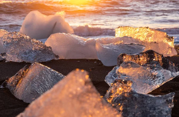 Diamond Beach in Iceland. Icebergs Shining on Black Volcanic Sand at Sunset. Clear Ice Crashed by Ocean Waves. Famous Tourist Location in North Europe Country. Travel Destination. High Resolution.