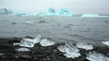 Blue Iceberg in Foggy Glacier Lagoon, Pure Nature in Iceland. Beautiful Natural Miracle in North Country. Ancient Blue Ice Is Melting Due To Global Warming. Winter and Ice Concept. Shot in 8k.