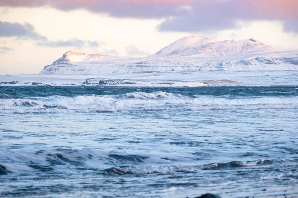 Icelandic Fjords During Sunset. Ocean Coast With Snow Covered Mountains. Winter Landscape in the North Europe Country. Landscape in Iceland.