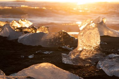 Diamond Beach in Iceland. Icebergs Shining on Black Volcanic Sand at Sunset. Clear Ice Crashed by Ocean Waves. Famous Tourist Location in North Europe Country. Travel Destination. High Resolution.
