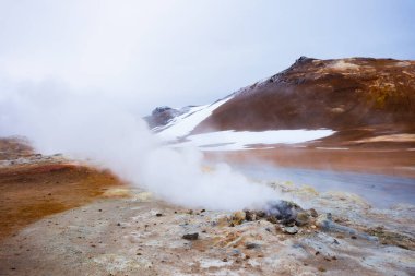 Geothermal Area in Iceland, Pure Green Energy at Sulfur Valley with Smoking Fumaroles. Famous tourist spot Hverir. Real Volcanic Activity near Myvatn lake. Evaporating water. Shot in 8k resolution.