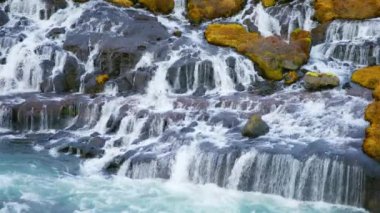 Autumn Waterfall in Iceland. Pure Turquoise Water in Mountain River. Popular Tourist Spot. Famous Travel Destination. Beautiful Nature, Unusual Landscape. Footage Shot in 8K Resolution 4320p.