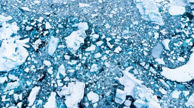 Melting Arctic Ice in Ocean Water. Blue Glacier Ice Covered with Snow in Iceland. Climate Crisis. High quality photo