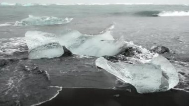 Iceberg in Foggy Glacier Lagoon, Nature in Iceland. Beautiful Natural Miracle in North Country. Pure Blue Ice at Winter Season. Blocks of Ice Wash Up on the Shore Shot in 8k Resolution.