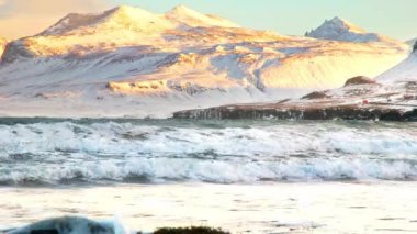 Icelandic Fjords During Sunset. Ocean Coast With Snow Covered Mountains. Winter Landscape in the North Europe Country. Landscape in Iceland Shot in 8k Resolution 4320p. High quality 4k footage