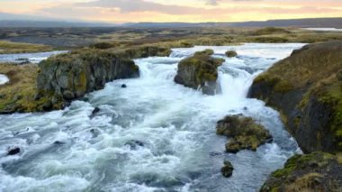 Autumn Waterfall in Iceland. Pure Turquoise Water in Mountain River. Popular Tourist Spot. Famous Travel Destination. Beautiful Nature, Unusual Landscape. Footage Shot in 8K Resolution 4320p.