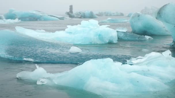 フォギー氷河ラグーンの青氷山 アイスランドの純粋な自然 北の国の美しい自然の奇跡 古代の青い氷は 地球温暖化のために氷解しています 冬と氷の概念 8Kで撃たれた — ストック動画